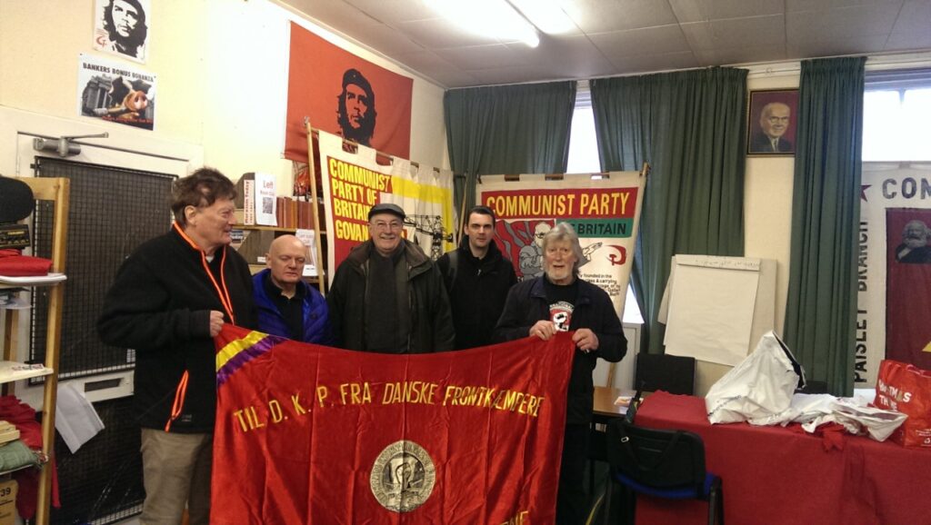 The party offices in Glasgow – Allan and Iain with the flag from the Danish volunteers in the Spanish Civil war to the Danish Communist Party, DKP – part of a photo reportage of the unveiling of the monument 'Blockade-Runners to Spain' in Glasgow, 2. March 2019