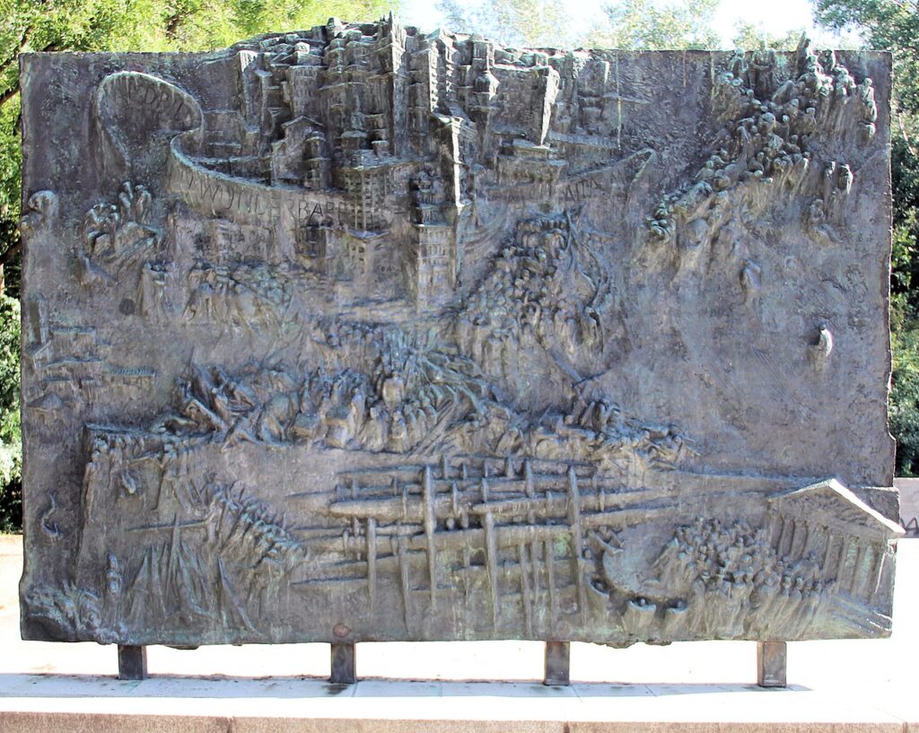Reliefbåndet i det tyske spaniensmonument “Spanienskæmperen” af Siegfried Krepp i Volkspark Friedrichshain (Folkeparken Friedrichshain), Berlin-Friedrichshain, Tyskland (det tidligere Østtyskland)